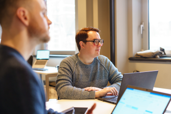 Two men working at laptops