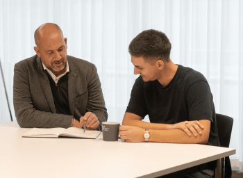 Two men working at a desk